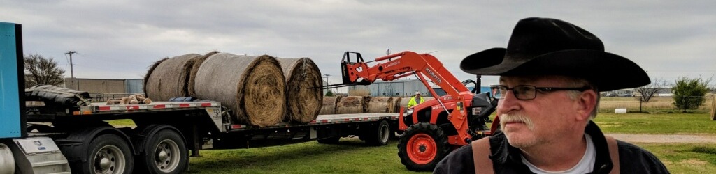 Man Loading hay on semi truck
